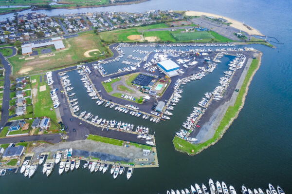 Aerial view of a marina with rows of boats moored in numbered slips.