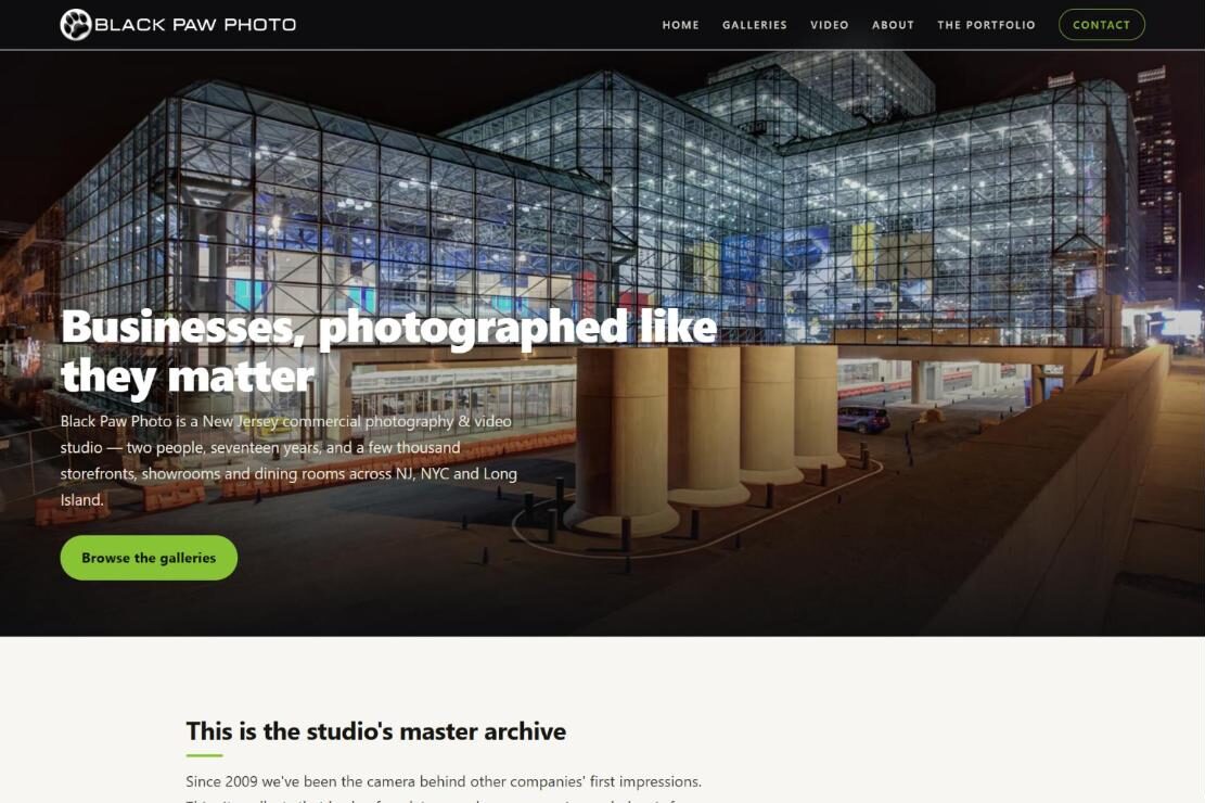 Black Paw Photo home page: a night photo of a glass convention center under the headline “Businesses, photographed like they matter”