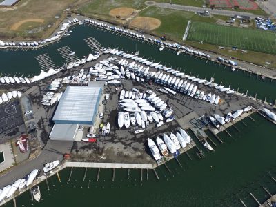Aerial photograph of a marina with boats berthed along its docks and jetties.