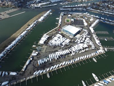 High aerial view of a marina and surrounding waterway dotted with boats.