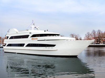 Large luxury motor yacht berthed at a dock on a clear day.