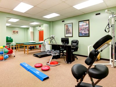 Physical therapy gym stocked with conditioning and mobility equipment.