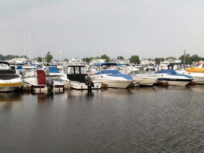 Powerboats moored along a dock at a Long Island marina on calm water.