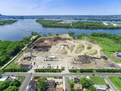 Aerial of a riverside redevelopment site being cleared and graded along the Delaware River in Camden, New Jersey.