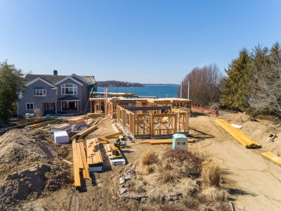 Waterfront home being framed with the bay and evergreens behind it in Northport, New York.