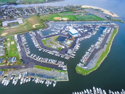 Aerial view of a marina with rows of boats moored in numbered slips.